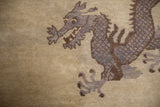 Hand-knotted detail of a mauve and brown five-toed dragon on an antique Peking rug.