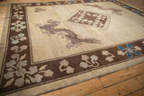 A five-toed dragon in mauve tones guards the corner of an antique Chinese Peking carpet.