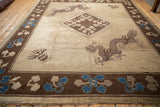 Antique Peking rug corner showing the five-toed dragon, central medallion, and blue floral border.