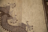 Close-up of a dragon's scaled body in brown and mauve, showing the hand-knotted low pile.