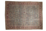 Distressed vintage Tabriz rug with a floral design in dusty teal and a warm burgundy border.