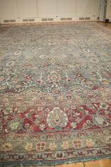 A low-angle view across the vintage Tabriz carpet, showing the rich burgundy border and the sprawling dusty teal field.