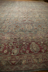 Low-angle view showing the textured, worn pile of a vintage Tabriz carpet at its border.