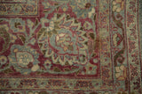 Intricate palmettes and scrolled vines in dusty teal and burgundy on a low pile Tabriz.