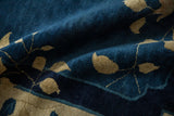 A draped section of an antique Peking carpet highlights its short, dense cobalt blue pile.