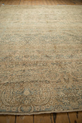 Low perspective on a distressed Kerman carpet highlighting its allover floral field and worn texture.