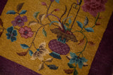 Hand-knotted texture of a gold Art Deco rug with purple and blue botanical motifs.