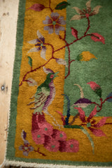 Art Deco bird and floral details in jade green, gold, and mauve on a hand-knotted Nichols rug.