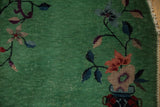 Detail showing low pile and visible foundation on the jade green field of a vintage Art Deco rug.