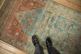 Standing view of the distressed texture and Herati lattice on a vintage Malayer rug runner.