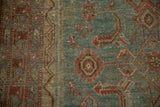 Detail of the worn texture showing knot heads on a vintage Persian Malayer runner.