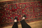 Hand knotted Persian Sarouk runner with cherry red field and allover floral crown shyness design.