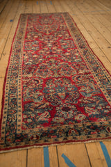 Cherry red Sarouk rug runner with navy, sapphire, and jade floral sprays in crown shyness formation.
