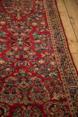 Cherry red field of a vintage Sarouk runner with distinct sapphire, navy, and jade floral sprays.