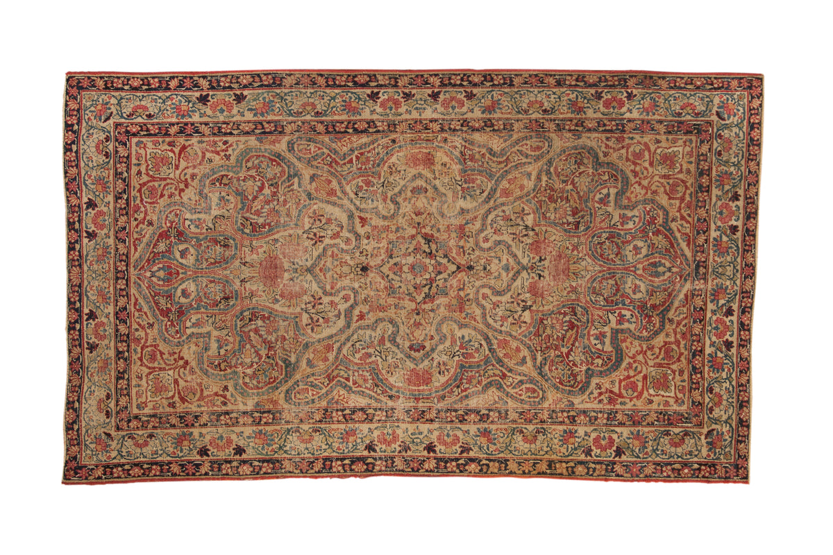 Antique Persian Kerman rug, fluid vinery, starburst medallion, ivory field, cochineal red, sapphire blue.