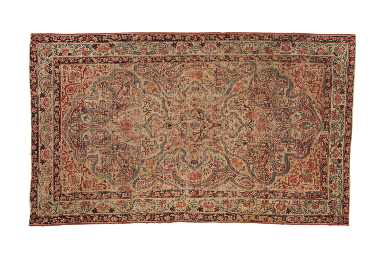Antique Persian Kerman rug, fluid vinery, starburst medallion, ivory field, cochineal red, sapphire blue.