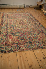 Patinaed fluid vinery and floral border patterns of an antique Kerman rug.