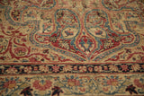 Antique Kerman rug detail, low pile revealing intricate red, navy, and ivory vinery and border.