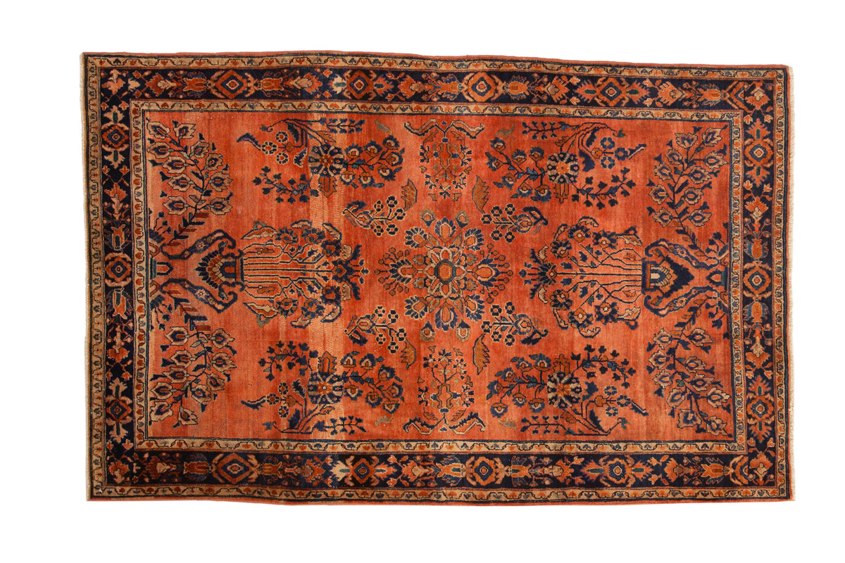 Transitional Sarouk rug in dusty rose with navy blue floral motifs and subtle abrash, 4'3" x 6'7".