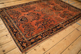 Transitional Sarouk corner, detailed dark navy border, terra cotta field, subtle abrash.