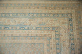 Distressed Persian Mir Sarouk corner with sand and sky blue banded patterns.