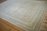 Distressed Mir Sarouk carpet with sand and sky blue multi-banded and boteh patterned borders.