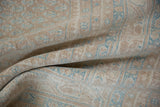 Close-up of worn, distressed vintage Mir Sarouk rug showing sky blue botehs on sand field.
