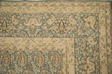 Corner detail of distressed vintage Meshed rug, showing dusty denim blue boteh and ivory border.