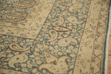 Distressed vintage Persian Meshed carpet with dusty denim blue and ivory boteh pattern.