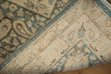 Distressed blue boteh pattern and hand-knotted foundation of a vintage Persian Meshed rug.