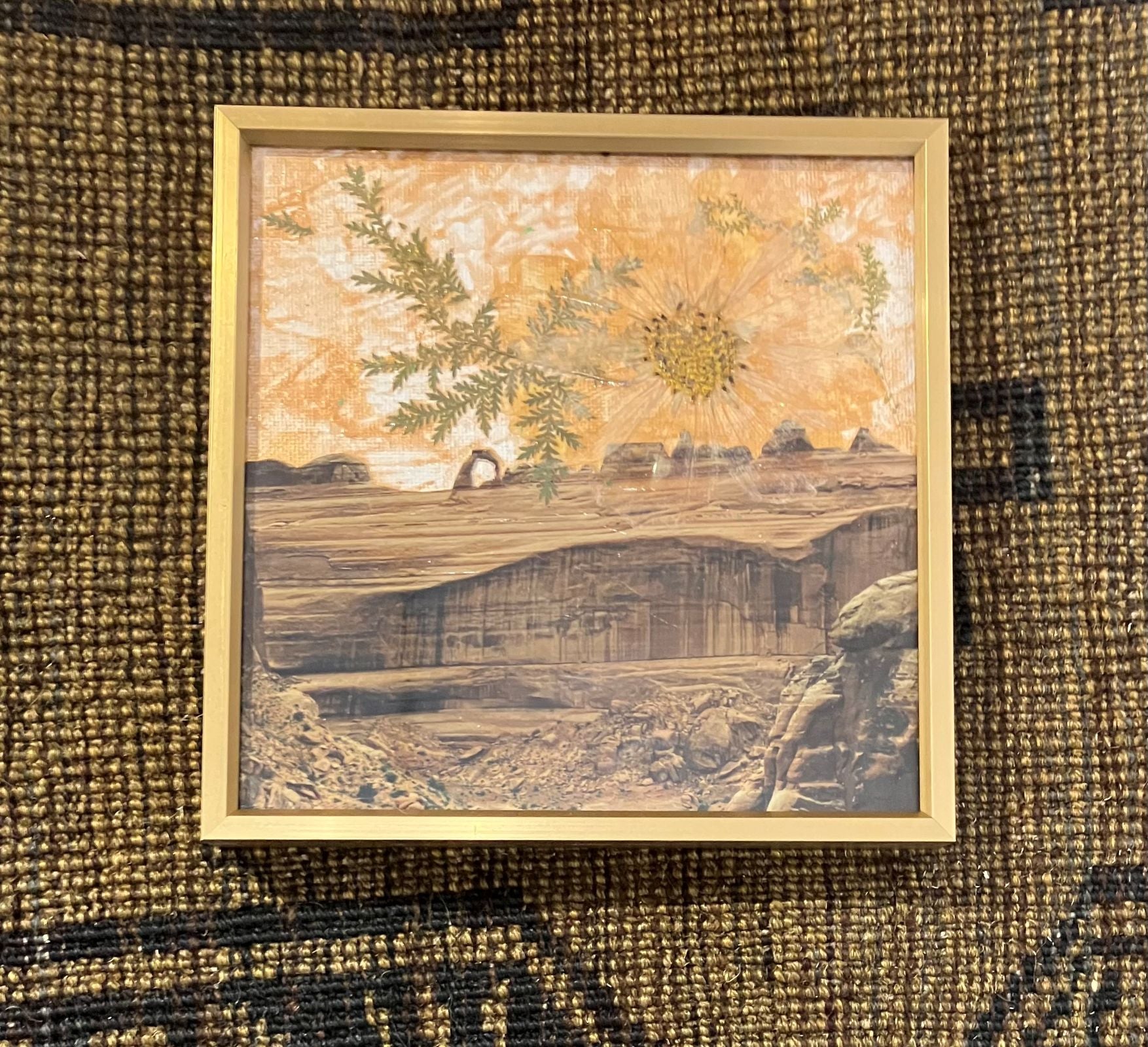 Framed mixed media "Desert Bloom" art featuring arid landscape photography, dried botanicals, and peach-toned painted sky.