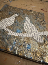 Textured faux silver leaf surface, blue accents, and a section of vintage text.