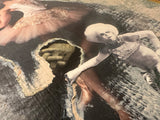 Mixed media artwork detail with torn paper ephemera and a collaged hand.