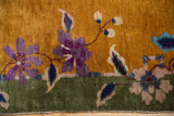 Art Deco purple floral and blue leaf detail on green border of vintage Nichols rug.
