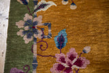 Vintage Art Deco Nichols rug with green border, gold field, stylized pink, blue blossoms, purple tendrils.