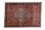Vintage hand-knotted Bijar rug: pomegranate red Herati field, sky blue angular medallion, navy border.