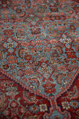 Vintage Bijar rug, detailed Herati motif in sky blue, pomegranate, and blush tones.