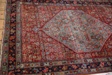 Vintage Bijar rug corner showcasing navy and sky blue borders with intact selvage.