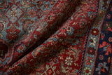 Vintage Bijar rug showcasing dense Herati pattern in rich pomegranate, sky blue, and navy.