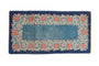 Vintage Chinese Art Deco runner with cobalt blue floral border and open sky blue field.