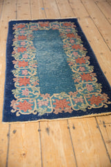 Stylized lotus and vine border in apricot, celadon, and cobalt on a faded blue Art Deco Chinese runner.