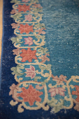Art Deco border with blush lotus forms, celadon tendrils, and sky blue field showing wear.