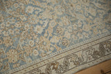 Detail of distressed Hamadan runner: pale blue and beige henna plant motif, rhythmic vine border.