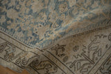 Visible wear on distressed Hamadan runner, showing faded blue henna plant motifs and brown vine border.
