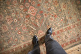 Hand-knotted antique Mahal carpet with germinating plant and pinwheel florals in olive, blush, and terra cotta.
