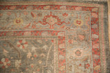 Antique Persian Mahal carpet corner: soft olive field with blush and copper lattice-oriented floral vines.