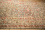 Antique Mahal carpet's lattice field with blush, copper, and olive green floral vines and aged texture.
