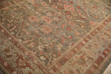 Delicate floral vines and pinwheel motifs in blush, olive, and terra cotta on this antique Mahal rug.