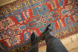 Antique Northwest Persian rug runner with brick red, sapphire blue, blush serrated patterns underfoot.
