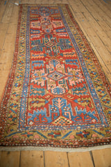 Geometric brick red and sapphire blue serrated motifs on an antique Persian runner.